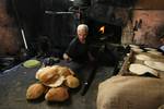 A Palestinians bake bread at a traditional bakery in the Palestinian Rafah refugee camp, in the southern Gaza Strip on September 24, 2012. 