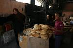 A Palestinians bake bread at a traditional bakery in the Palestinian Rafah refugee camp, in the southern Gaza Strip on September 24, 2012. 