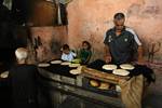 A Palestinians bake bread at a traditional bakery in the Palestinian Rafah refugee camp, in the southern Gaza Strip on September 24, 2012. 