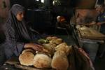 A Palestinians bake bread at a traditional bakery in the Palestinian Rafah refugee camp, in the southern Gaza Strip on September 24, 2012. 