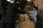 A Palestinians bake bread at a traditional bakery in the Palestinian Rafah refugee camp, in the southern Gaza Strip on September 24, 2012. 