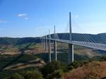 The Millau Viaduct (French: le Viaduc de Millau, Occitan: lo Viaducte de Milhau) is an enormous cable-stayed road-bridge that spans the valley of the river Tarn near Millau in southern France. Designed by the structural engineer Michel Virlogeux and British architect Norman Foster, it is the tallest vehicular bridge in the world, with one mast's summit at 343 metres (1,125 ft) — slightly taller than the Eiffel Tower and only 37 m (121 ft) shorter than the Empire State Building. The viaduct is pa