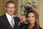 England soccer captain David Beckham poses with his wife Victoria, as he holds the OBE, Order of the British Empire, he received Thursday, Nov. 27, 2003, from Britain´s Queen Elizabeth II at London´s Buckingham Palace. The former Manchester U