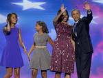 President Barack Obama and First lady Michelle Obama waves to delegates as their daughters Malia and Sasha join them at the Democratic National Convention in Charlotte, N.C., on Thursday, Sept. 6, 2012.