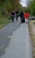 EAST PROVIDENCE, R.I. - Two bicyclists make their way down the East Bay Bike Path as Coast Guard Chief Petty Officer Lisa Machon (left) and her mom Cathy Machon (right) carry bags of trash. Men and women from the Coast Guard and the East Providence Police Department spent the morning picking up litter along the path Saturday, May 3, 2008. (Coast Guard photo/Lauren Jorgensen) (269320) ( Bike Path Cleanup (FOR RELEASE) )