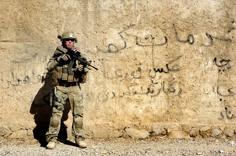 U.S. Army Staff Sgt. James Bates, with Provincial Reconstruction Team (PRT) Farah, pulls security during a mission to the director of information and culture's office in Farah City, Farah province, Afghanistan, Sept. 25, 2012.