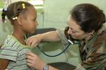 Lt. Shellie Kendall, a pediatrician embarked aboard the Military Sealift Command hospital ship USNS Comfort (T-AH 20), checks the vital signs of patient Abigail Cruz.