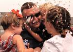 SANDY HOOK, N.J. (July 30, 2003)--Boatswain's Mate 1st Class Colin Redy, of the Coast Guard Cutter Adak homeported in Sandy Hook, NJ., celebrates with his children Abigail, 2, (left) and Bailey, 4, moments after returning home from Operation Iraqi Freedom. The Adak has been patrolling the Iraqi coast since February and continues to do so. USCG photo by PA1 Tom Sperduto (91005) ( WELCOME HOME (FOR RELEASE) )