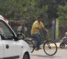 a bicyclist on the road - vehicle