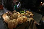 A Palestinians bake bread at a traditional bakery in the Palestinian Rafah refugee camp, in the southern Gaza Strip on September 24, 2012. 