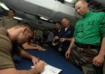 Ultimate Fighting Championship (UFC) fighter Rich Franklin signs his name for a Sailor during an autograph session on the mess decks aboard Nimitz-class aircraft carrier USS Harry S. Truman (CVN 75).