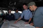 Quartermaster 3rd Class Christopher Bridges describes his job to Ultimate Fighting Championship (UFC) fighter Rich Franklin on the bridge of the Nimitz-class aircraft carrier USS Ronald Reagan (CVN 76).