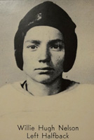 A man with a leather helmet and a white football jersey.