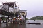 women of the Ijaw tribe arrive in boats at a ChevronTexaco oil flow station in Makaraba, Nigeria, to relieve other Ijaw women who are occupying the station Saturday, July 20, 2002. Chevron, one of the world's largest oil companies, has denied alleged humans rights and environmental violations in the 180 countries where it operates, but several attacks threaten its public image around the world. In Ecuador, the plaintiffs estimate it will cost $6 billion to clean up 18.5 billion gallons of oily w