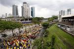 Protesters march on a street during a rally to demand for electoral reforms in Kuala Lumpur, Malaysia, Saturday, April 28, 2012. Police unleashed tear gas and chemical-laced water Saturday at thousands of demonstrators who staged one of Malaysia's largest street rallies in years, demanding fair rules for national elections expected soon. (AP Photo/Lai Seng Sin)