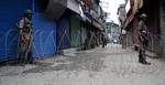 Indian paramilitary troops stand infront of razore wire during a curfew in downtown area of Srinagar, the summer capital of Indian Kashmir, 26, June, 2012. Authorities imposed curfew in old part of Srinagar city in anticipation of clashes over shrine blaze. The historical shrine of 11th century saint, Sheikh Syed Abdul Qadir Jeelani (locally called Dastgeer Sahib) gutted in devastating fire on Monday. The fire caused massive damage to two centuries old shrine. Soon after the shrine blaze clashes