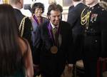 2011 National Medal of the Arts recipients, actor, Al Pacino, center, and poet and author Rita Dove, rear, leave the East Room of the White House in Washington, Monday, Feb. 13, 2012, following the awards ceremony. (AP Photo/Pablo Martinez Monsivais)