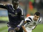 Belgium's RSC Anderlecht player Romelu Lukaku, left, fouls Romania's Timisoara player Florin Maxim, during the Europa League soccer match in Brussels, Belgium, Thursday Nov. 5, 2009