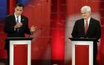 Republican presidential candidates former Massachusetts Gov. Mitt Romney, left, gestures as he talks to former House Speaker Newt Gingrich during a Republican presidential debate Monday Jan. 23, 2012, at the University of South Florida in Tampa, Fla.