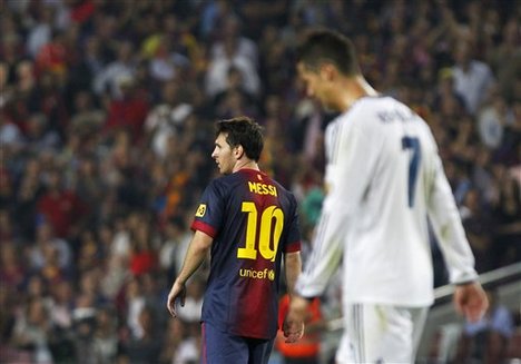 Real Madrid's Cristiano Ronaldo from Portugal, left, and FC Barcelona's Lionel Messi from Argentina, right, gestures during a Spanish La Liga soccer match at the Camp Nou stadium in Barcelona, Spain, Sunday, Oct. 7, 2012.