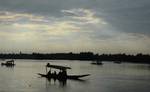 Amidists a spell of rains in Srinagar on Saturday on 25, August 2012. A Group of Tourists enjoy shikara ride waters of Dal lake.