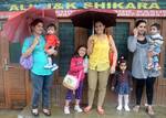 Tourists enjoy banks of Dal Lake during a rain in Srinagar on Sunday 09, September 2012. Incessant rains continued to lash Kashmir since Saturday night, sparking crop damage fears among the farming community of the Valley.