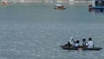 School childrens ride boat return home at Dal Lake in Srinagar on 23, August 2012.