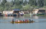 Kashmiri students enjoy shikara ride on the waters of Dal Lake in Srinagar, India, on 03, September 2012.