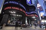 A police officer stands guard in New York's Times Square as the ABC news ticker displays news of an al-Qaida terror threat, Friday, Sept. 9, 2011.