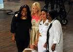 Presenters Sherri Shepherd, left, Elizabeth Hasselbeck, second from left, and Whoopi Goldberg, right, pose for a photograph with U.S. Navy Rear Adm. Michelle Howard, commander, Expeditionary Strike Group 2, at a taping of the ABC television talk show ?The View? attended by U.S. Sailors, Marines and Coast Guard Sailors in New York City, N.Y., May 27, 2010, during Fleet Week New York 2010. New York City has conducted Fleet Week, honoring the sea services in a weeklong annual series of events, sinc