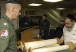 Meyer Malka, a French Rabbi, opens the Torah with Lt. Zachary Stang during a Jewish service aboard USS Harry S. Truman (CVN 75).