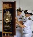 Lt. Elizabeth Steffen, right, and Lt. Julia Weber close the door of the ark protecting a Jewish Torah at the conclusion of the Torah dedication ceremony in the hangar bay of the Nimitz-class aircraft carrier USS Harry S. Truman (CVN 75).