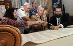 Torah dedication ceremony participants write one of the last letters in a new Sefer Torah at the Aloha Jewish Chapel at Naval Station Pearl Harbor.