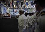 Truman Sailors listen to Sen. Carl Levin as he speaks during the Torah Dedication Ceremony in the hangar bay of Nimitz-class aircraft carrier USS Harry S. Truman (CVN 75).