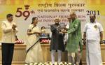 The Vice President, Shri Mohd. Hamid Ansari presenting the Dadasaheb Phalke Award 2011 to Shri Soumitra Chatterjee, at the 59th National Film Awards function, in New Delhi on May 03, 2012.The Union Minister for Information and Broadcasting, Smt. Ambika Soni, the Ministers of State for Information and Broadcasting, Shri Chowdhury Mohan Jatua and Dr. S. Jagathrakshakan and the Secretary, Ministry of Information & Broadcasting, Shri Uday Kumar Varma are also seen.