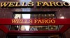 In this May 6, 2012, file photo, a Wells Fargo sign is displayed at a branch in New York. Wells Fargo is reporting higher earnings and revenue for the third quarter, thanks to higher fees a rise in trading revenue.