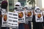 Muslim women hold posters during a protest against Lady Gaga's concert that is scheduled to be held on June 3, in Jakarta, Indonesia, Thursday, May 24, 2012. Lady Gaga might have to cancel her sold-out show in Indonesia because police worry her sexy clothes and dance moves undermine Islamic values and will corrupt the country's youth. The writings on the posters read 