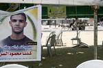 The family of Palestinian prisoner Mahmud Al-Sarsak sit in front of his images at their home, as they prepare for his release from an Israeli jail, on July 9, 2012. Sarsak, who should be released on July 10 following weeks of being on hunger strike, is a football player from the Gaza Strip and was detained by Israeli troops while traveling to play with the Palestinian team in the Israeli occupied Palestinian West Bank.Photo by Ahmed Deeb/wn