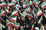 Iranian women wave national flags and hold posters showing supreme leader Ayatollah Ali Khamenei and President Mahmoud Ahmadinejad before Ahmadinejad's speech on the strategic Persian Gulf island of Abu Musa, Wednesday, April 11, 2012. Ahmadinejad visited Abu Musa in the first trip by a head of state since Tehran retook possession of the island 41 years ago.