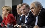 From left, German Chancellor Angela Merkel, Jose Angel Gurria, secretary general of the Organisation for Economic Co-operation and Development (OECD), Robert Zoellick, President of the World Bank, and Dominique Strauss-Kahn, managing director of the International Monetary Fund address the media after a meeting at the Chancellery in Berlin, Germany, Wednesday, April 28, 2010.