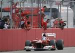 Spains Ferrari driver Fernando Alonso celebrates with teammates after winning the German F1 Grand Prix in Hockenheim, Germany