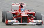 Ferrari driver Fernando Alonso of Spain celebrates as he crosses the finish line to win the German Formula One Grand Prix in Hockenheim, Germany