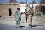 U.S. Marine Corps Lance Cpl. Dylan Lee, a rifleman with the 1st Squad, 1st Platoon, Kilo Company, 3rd Battalion, 8th Marine Regiment, Regimental Combat Team 6, talks with a boy during a security patrol in the Garmsir district of Helmand province, Afghanistan, Oct. 7, 2012. Marines conducted the patrol in an effort to disrupt enemy activity in the area. (U.S. Marine Corps photo by Lance Cpl. Cesar Contreras/Released)