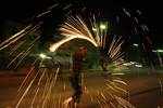 A Palestinian boys play with fire crackers as they celebrate the beginning of Ramadan, a holy month of dawn-to-dusk fasting, festivities and abstinence in Rafah, southern Gaza Strip on July 18, 2012. The Muslim holy month of Ramadan begins Friday 20 July or Saturday 21 July, is traditionally determined by the sighting of a new crescent moon, often dividing rival Islamic countries and sects over the exact date.Photo by Ahmed Deeb / WN