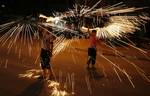 A Palestinian boys play with fire crackers as they celebrate the beginning of Ramadan, a holy month of dawn-to-dusk fasting, festivities and abstinence in Rafah, southern Gaza Strip on July 18, 2012. The Muslim holy month of Ramadan begins Friday 20 July or Saturday 21 July, is traditionally determined by the sighting of a new crescent moon, often dividing rival Islamic countries and sects over the exact date.Photo by Ahmed Deeb / WN