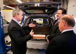 President George W. Bush views a hybrid vehicle powered by Lithium-ion batteries during a tour by Johnson Controls´ CEO John Barth, far right, and employee Mike Andrew at the Johnson Controls´ Battery Technology Center in Glendale, Wisconsin(