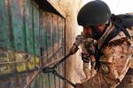 A member of the Afghan Narcotics Interdiction Unit cuts a lock on a suspected insurgent compound during Operation Speargun in Urmuz, Afghanistan, March 26, 2012. The five-day operation was intended to disrupt enemy activity and set the conditions to allow Afghan National Security Forces to gain a foothold and move into an area with little previous established Government of the Islamic Republic of Afghanistan presence.