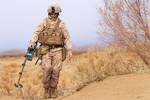 U.S. Marine Lance Cpl. Matthew Bayles, a point man with Alpha Company, 1st Light Armored Reconnaissance Battalion, and native of Plainfield, Ill., sweeps for weapons and drug caches during a patrol here, Feb. 16. Marines and sailors with 1st LAR and India Company, 3rd Battalion, 3rd Marine Regiment, conducted clearing and disrupting operations in and around the villages of Sre Kala and Paygel during Operation Highland Thunder. Marines with 1st LAR led the operation on foot, sweeping for enemy we