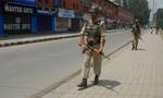 Indian paramilitary troopers patrol infront of closed shops during a one day strike, to commemorate the killing of dozens of local youth in alleged police actions during the 2008-2010 civilian unrest, called by hardline separatist leader Syed Ali Shah Geelani in Srinagar on June 11,2012.