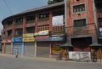 Indian paramilitary troopers stand infront of closed shops during a one day strike, to commemorate the killing of dozens of local youth in alleged police actions during the 2008-2010 civilian unrest, called by hardline separatist leader Syed Ali Shah Geelani in Srinagar on June 11,2012. Geelani accused Indian authorities of allegedly inflecting atrocities on the people of Kashmir as part of 'repressing measures'. An armed insurgency against Indian rule in Kashmir has claimed 47,000 lives since 1